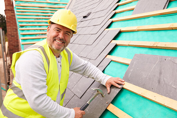 A roof contractor installing a new roof shingles