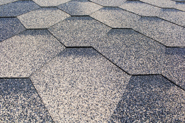 close up of grayish architectural shingle roofing with unique design 