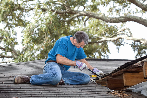 homeowner inspecting parts of his roofing